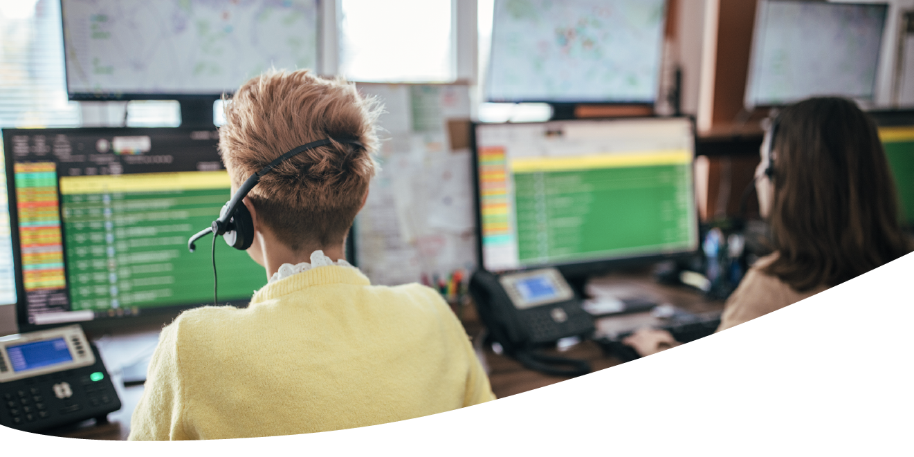Image of people looking at screens in an alarm monitoring centre
