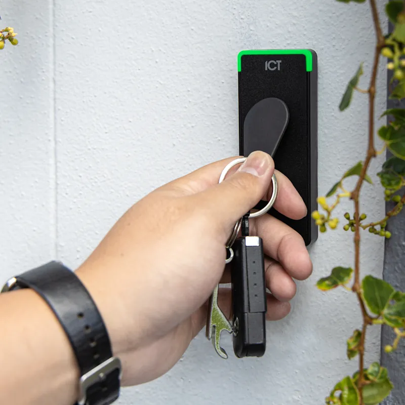 person badging a reader with a fob credential