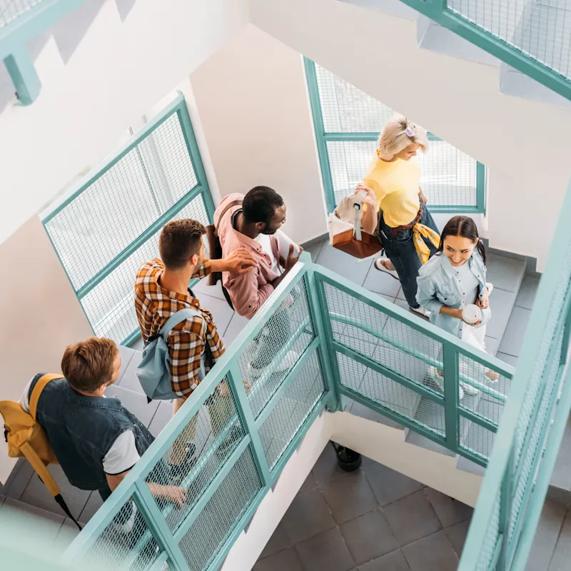 Students walking down stairs at a school
