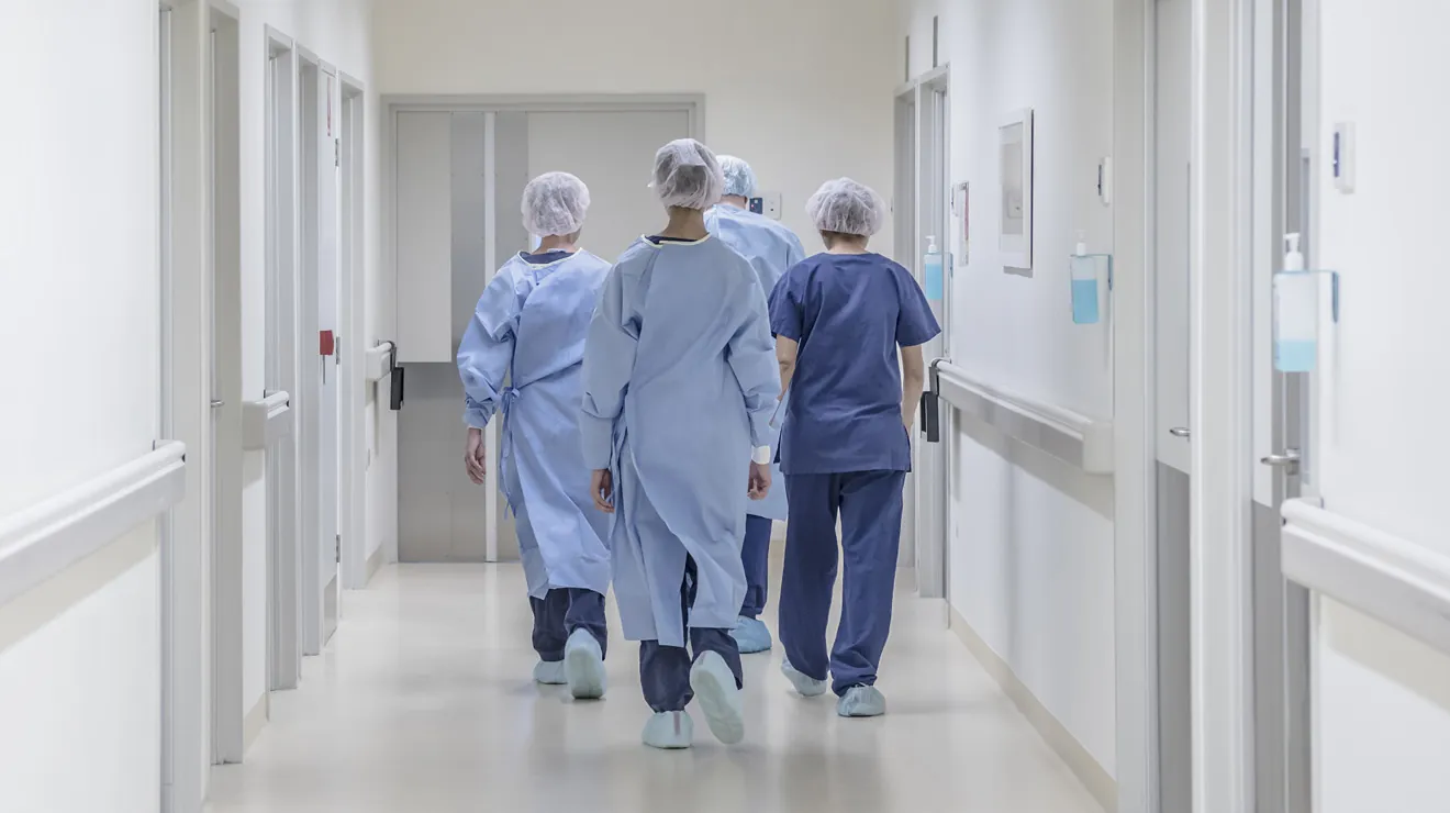 Medical staff walking through a hospital