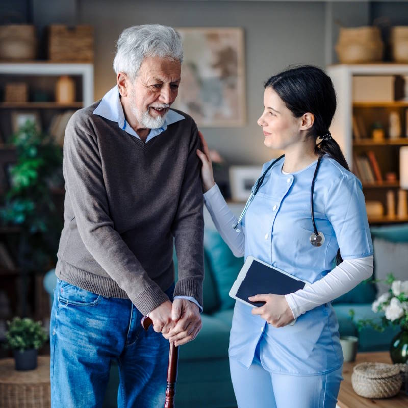 a staff member talking to a patient in an aged care facility